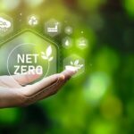 The_concept_of_carbon_neutral_and_net_zero._natural_environment_A_climate-neutral_long-term_strategy_greenhouse_gas_emissions_targets_with_green_net_center_icon_on_hand_cap_and_green_background