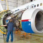 Replacing_the_engine_on_the_plane,_working_people_tap._Concept_maintenance_of_aircraft